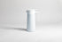 White cylincial pot with an white polypropylene spout, handle and lid. Set on a light gray background