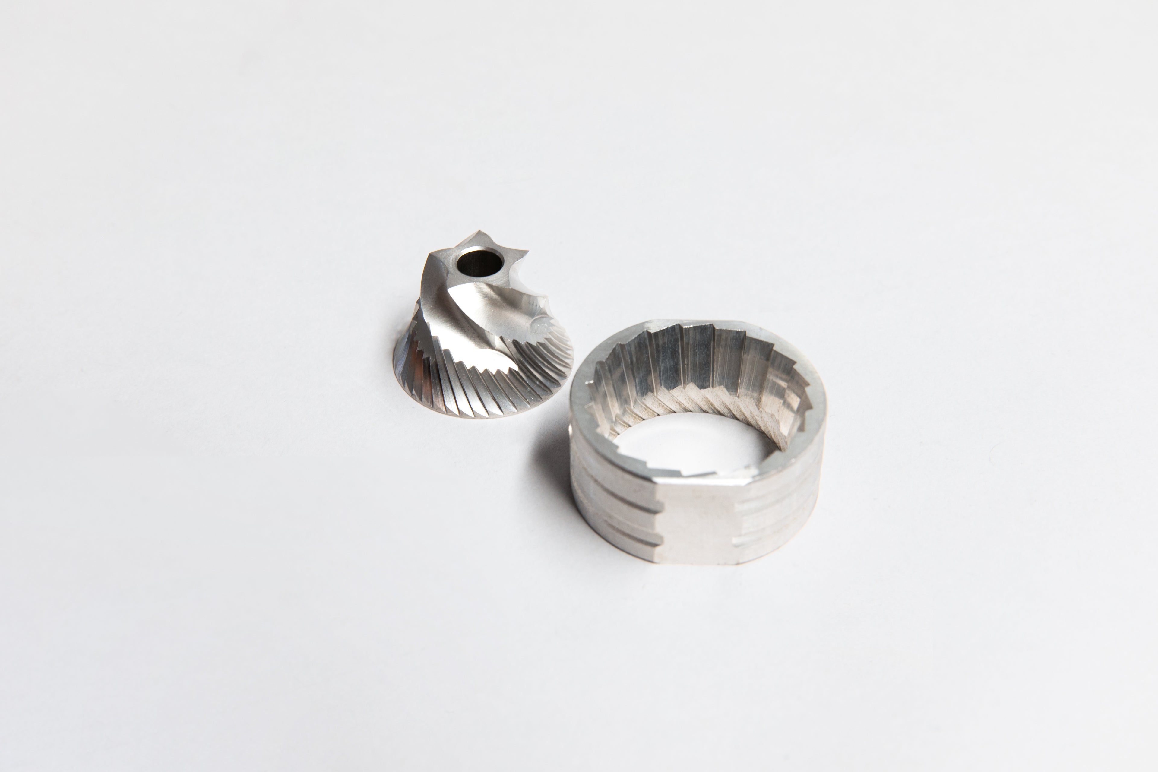 Stainless steel cone shaped inner and circular shaped outer burrs.