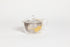 All glass tapered tea pot with flat bottom, all glass lid and handle, and metal mesh filter basket insert. decorated glass with a minimal floral motif in gold. set in a white background.